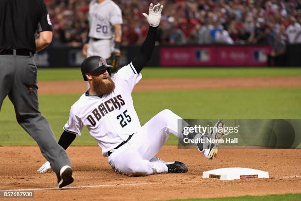 Archie Bradley of the Arizona Diamondbacks slides into third base during bottom of the seventh inning of the National League Wild Card game against...