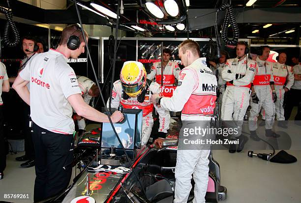 Lewis Hamilton of Great Britain and McLaren Mercedes climbs into his car before the Australian Formula One Grand Prix at the Albert Park Circuit on...