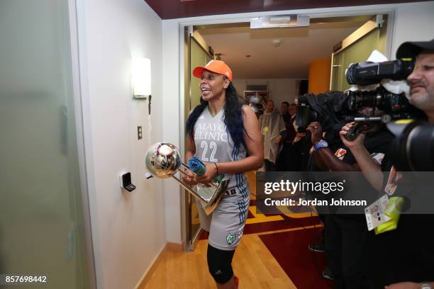 Plenette Pierson of the Minnesota Lynx holding the championship trophy heads to the locker room after defeating the Los Angeles Sparks in Game 5 of...