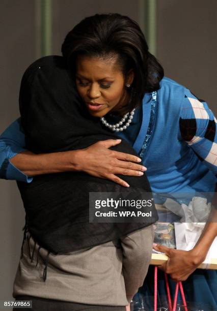 First Lady Michelle Obama embraces a student during a visit to the Elizabeth Garrett Anderson Secondary School on April 2, 2009 in Borough of...
