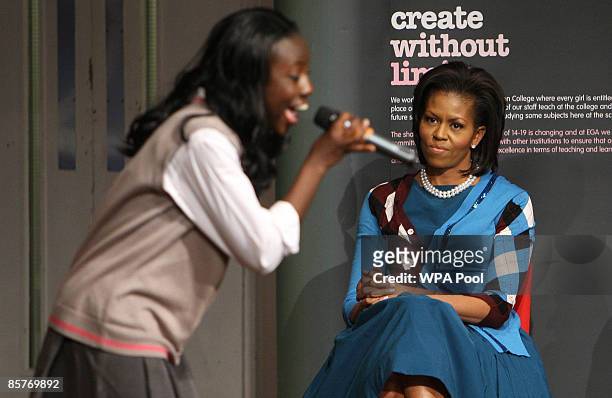 First Lady Michelle Obama watches a concert by pupils during a visit to the Elizabeth Garrett Anderson Secondary School on April 2, 2009 in Borough...