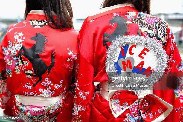 Pair of Ferrari fans show their support during previews ahead of the Formula One Grand Prix of Japan at Suzuka Circuit on October 5, 2017 in Suzuka.