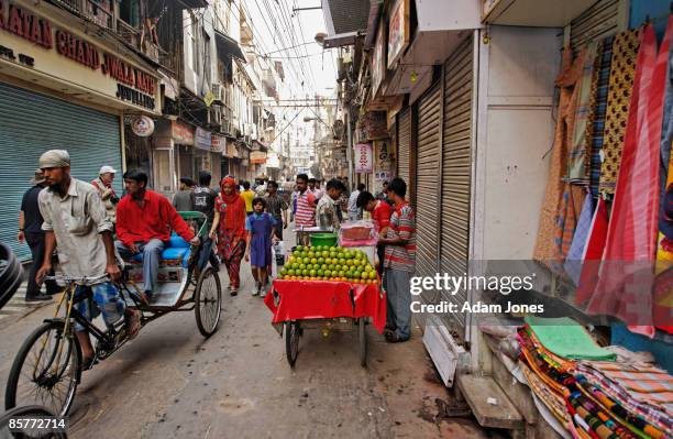 real people on the move in narrow gulley - delhi street stock pictures, royalty-free photos & images