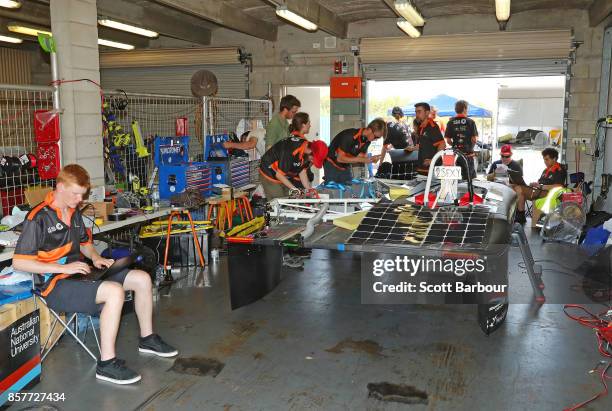 Team members prepare in their pit garage before MTAA Super Charge, the car from Australia's MTAA Super Sol Invictus is tested on track at the Hidden...