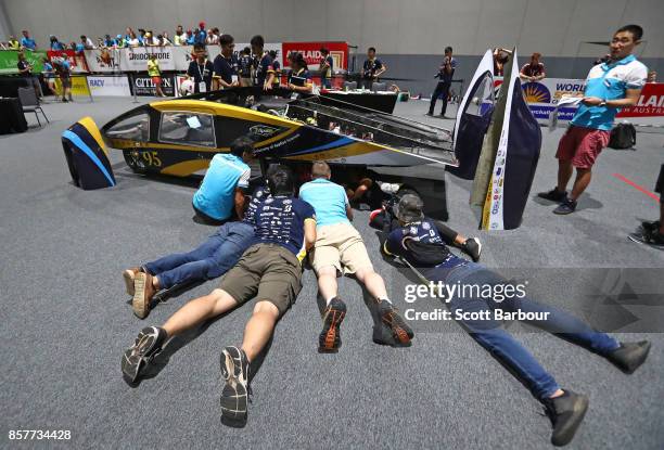 Team members look on as Apollo VIII, the car from Taiwan's National Kaohsiung University of Applied Sciences & St. John's University Solar Car Team...