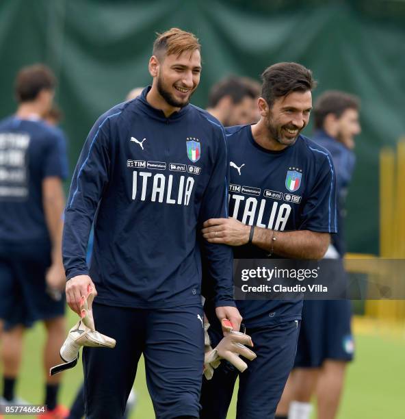 Gianluigi Buffon and Gianluigi Donnarumma of Italy chat during a training session at Italy club's training ground at Coverciano on October 5, 2017 in...