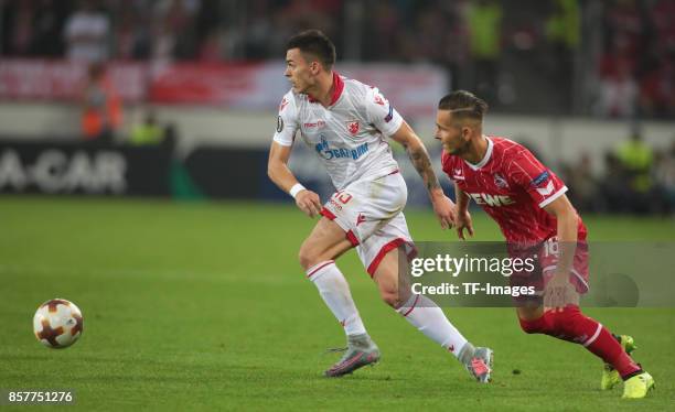 Nemanja Radonjic of Belgrad and Pawel Olkowski of Koeln battle for the ball during the UEFA Europa League group H match between 1. FC Koeln and...