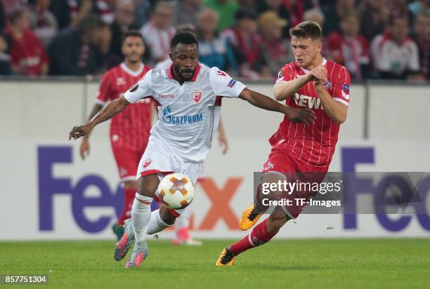 Guelor Kanga of Belgrad and Salih Oezcan of Koeln battle for the ball during the UEFA Europa League group H match between 1. FC Koeln and Crvena...