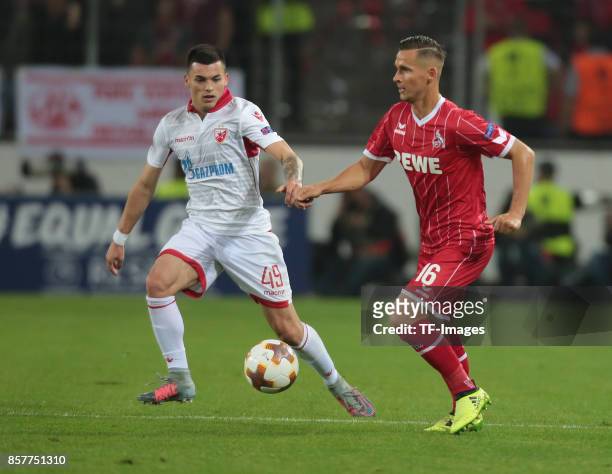 Nemanja Radonjic of Belgrad and Pawel Olkowski of Koeln battle for the ball during the UEFA Europa League group H match between 1. FC Koeln and...