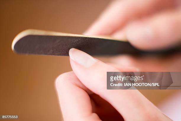 woman using emery board - nail file stock pictures, royalty-free photos & images