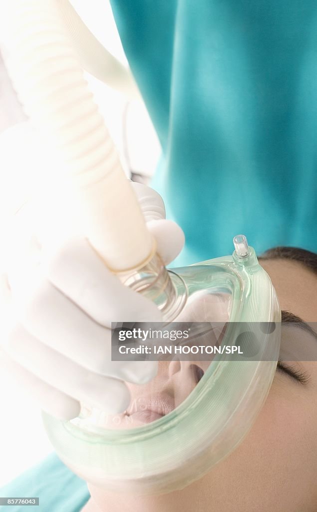 Anesthetist administering gas to patient