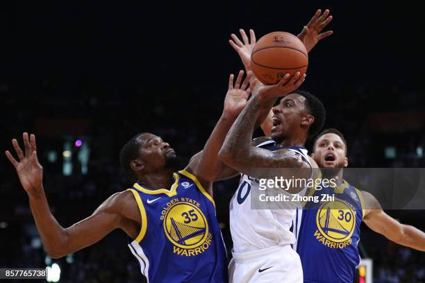 Jeff Teague of the Minnesota Timberwolves in action while Stephen Curry and Kevin Durant of the Golden State Warriors during the game between the...