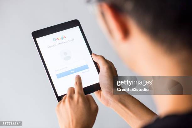 Man holds an Apple iPad Mini as he uses Google app on October 4, 2017 in Hong Kong, Hong Kong.