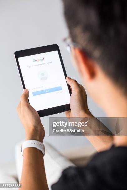 Man holds an Apple iPad Mini as he uses Google app on October 4, 2017 in Hong Kong, Hong Kong.