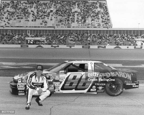 Buddy Baker driver of the Red Baron Pizza Oldsmobile, poses in front of his car before the 1988 Daytona 500 at the Daytona International Speedway on...