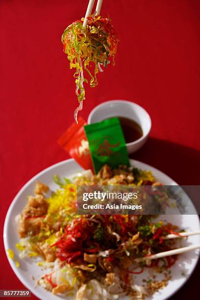 tossing raw fish salad also known as yu sheng or lo hei - prosperity toss stock pictures, royalty-free photos & images