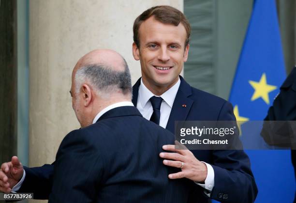 French President Emmanuel Macron welcomes Iraq's Prime Minister Haidar Al-Abadi prior to their meeting at the Elysee Presidential Palace on October...