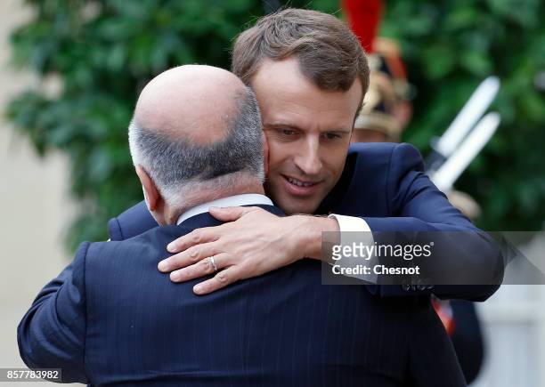 French President Emmanuel Macron welcomes Iraq's Prime Minister Haidar Al-Abadi prior to their meeting at the Elysee Presidential Palace on October...