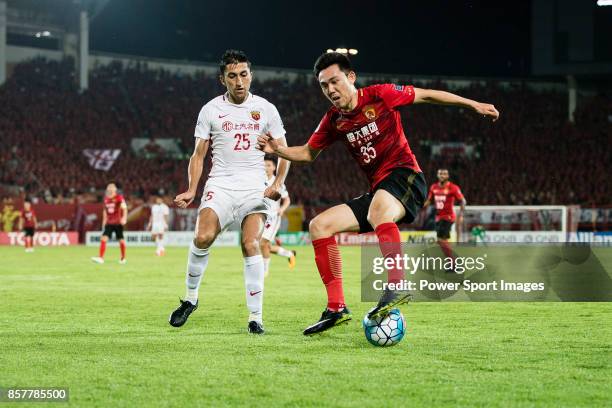 Shanghai FC Midfielder Akhmedov Odil in action against Guangzhou Defender Li Xuepeng during the AFC Champions League 2017 Quarter-Finals match...