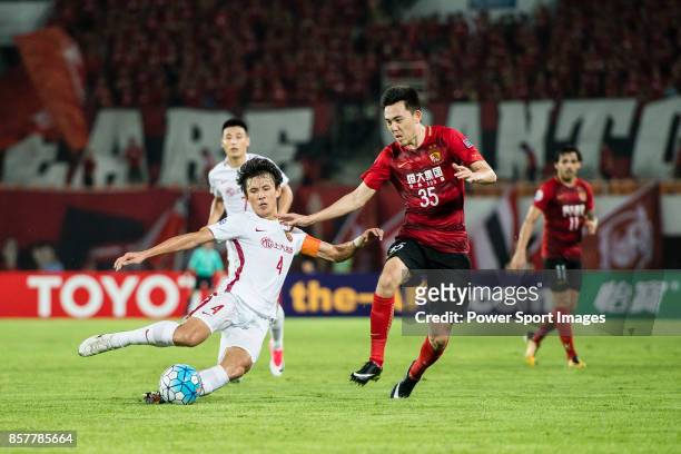 Shanghai FC Defender Wang Shenchao trips up with Guangzhou Defender Li Xuepeng during the AFC Champions League 2017 Quarter-Finals match between...