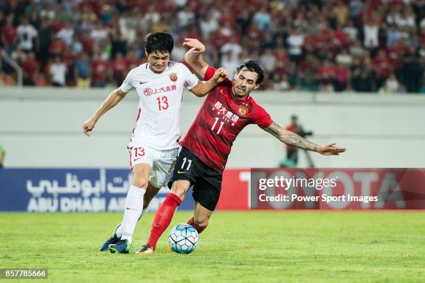 Guangzhou Forward Ricardo Goulart in action against Shanghai FC Defender Wei Zhen during the AFC Champions League 2017 Quarter-Finals match between...