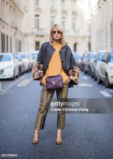 Gitta Banko wearing a mustard colored sweater from Mango, brocade jacket with fake fur trimming in leopard pattern by Steffen Schraut, pants with...
