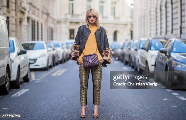 Gitta Banko wearing a mustard colored sweater from Mango, brocade jacket with fake fur trimming in leopard pattern by Steffen Schraut, pants with...