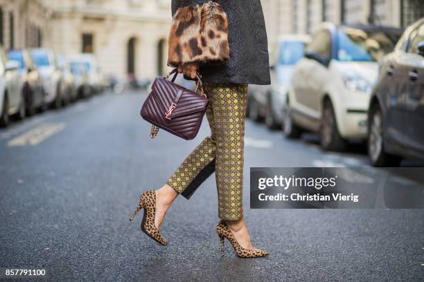 Gitta Banko wearing a mustard colored sweater from Mango, brocade jacket with fake fur trimming in leopard pattern by Steffen Schraut, pants with...