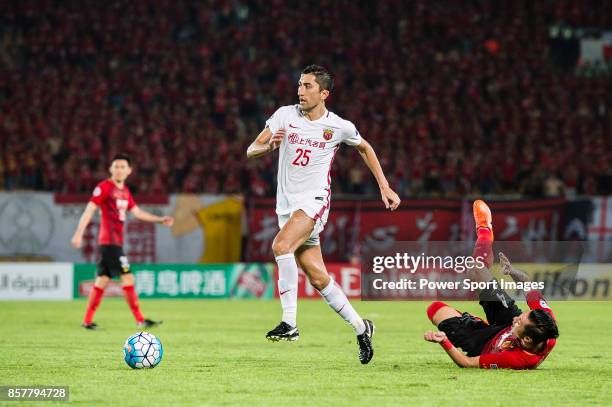 Shanghai FC Midfielder Akhmedov Odil in action against Guangzhou Midfielder Xu Xin during the AFC Champions League 2017 Quarter-Finals match between...