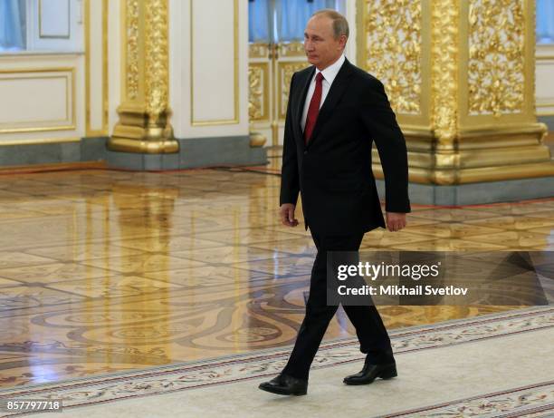 Russian President Vladimir Putin enters the hall during the reception ceremony for King Salman bin Abdulaziz Al Saud of Saudi Arabia at the Grand...