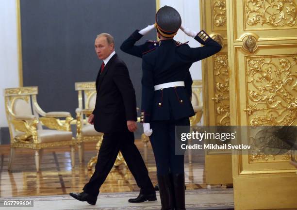 Russian President Vladimir Putin enters the hall during the reception ceremony for King Salman bin Abdulaziz Al Saud of Saudi Arabia at the Grand...