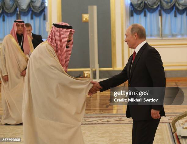 Russian President Vladimir Putin greets King Salman bin Abdulaziz Al Saud of Saudi Arabia at the Grand Kremlin Palaceon October 5, 2017 in Moscow,...