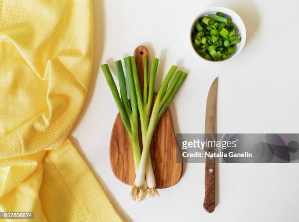 fresh green onions on white table - cebolla de primavera fotografías e imágenes de stock