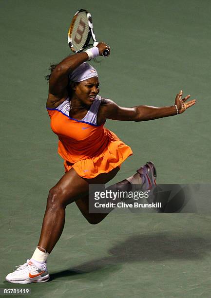 Serena Williams returns a shot during her semifinal match against Venus Williams at the Sony Ericsson Open at the Crandon Park Tennis Center on April...