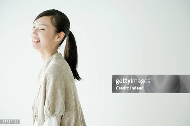 japanese young woman laughing, side view - ponytail stock pictures, royalty-free photos & images