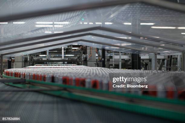 Empty soft-drink cans pass along a conveyor inside the Refresco Group NV beverage bottling factory in Maarheeze, Netherlands, on Thursday, Oct. 5....