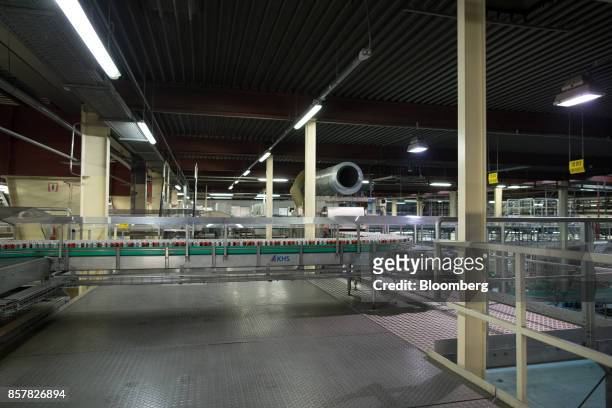 Empty soft-drink cans pass along a conveyor inside the Refresco Group NV beverage bottling factory in Maarheeze, Netherlands, on Thursday, Oct. 5....