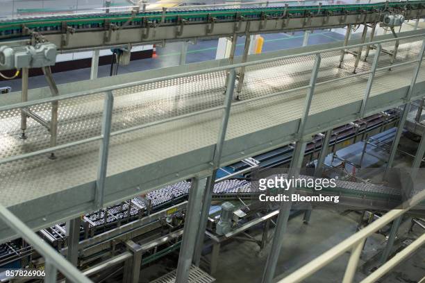 Filled soft-drink cans pass along conveyors inside the Refresco Group NV beverage bottling factory in Maarheeze, Netherlands, on Thursday, Oct. 5....
