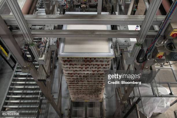 Filled soft-drink cans sit stacked at the end of the production line at the Refresco Group NV beverage bottling factory in Maarheeze, Netherlands, on...