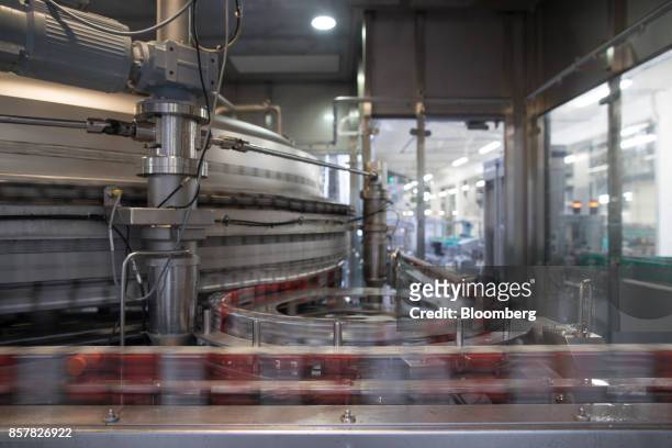 Cans of soft-drink cans pass along a conveyor during filling inside the Refresco Group NV beverage bottling factory in Maarheeze, Netherlands, on...