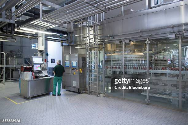 An employee monitors the soft-drink can filling line inside the Refresco Group NV beverage bottling factory in Maarheeze, Netherlands, on Thursday,...