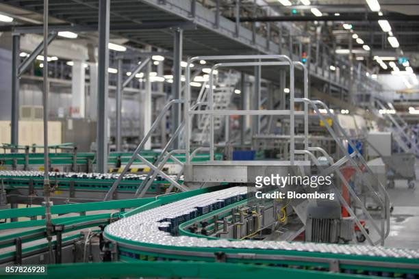 Filled soft-drink cans pass along a conveyor inside the Refresco Group NV beverage bottling factory in Maarheeze, Netherlands, on Thursday, Oct. 5....