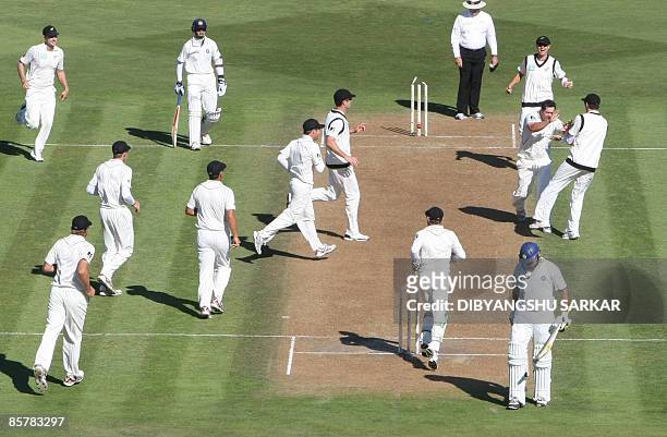 New Zealand cricketers congratulate Jesse Ryder for taking the wicket of Indian batsman Yuvraj Singh during the first day of the final Test match...