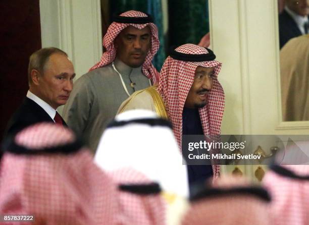 Russian President Vladimir Putin and King Salman bin Abdulaziz Al Saud of Saudi Arabia arrive for a meeting at the Grand Kremlin Palaceon October 5,...