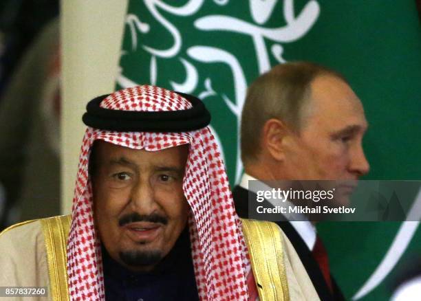 Russian President Vladimir Putin and King Salman bin Abdulaziz Al Saud of Saudi Arabia arrive for a meeting at the Grand Kremlin Palaceon October 5,...