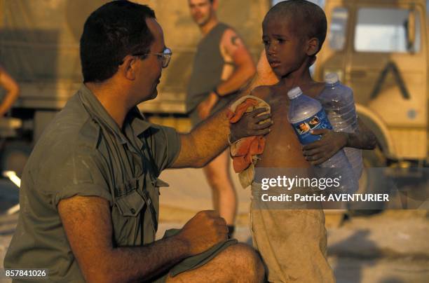 Un soldat de l'armee francaise a Hodur parle avec un petit garcon pendant l'operation militaire Restore Hope en janvier 1993 en Somalie.