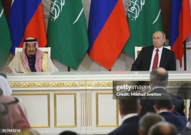 Russian President Vladimir Putin and King Salman bin Abdulaziz Al Saud of Saudi Arabia take part in a meeting at the Grand Kremlin Palace on October...
