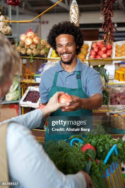 man selling vegetables - greengrocer stock pictures, royalty-free photos & images
