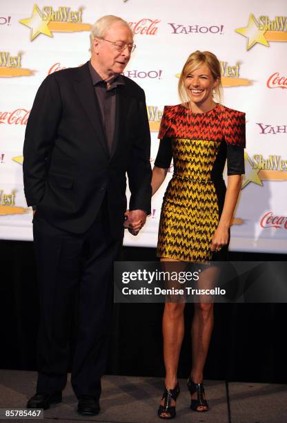 Lifetime Achievement Award recipient Michael Caine and Supporting Actress of the Year Sienna Miller poses for photos in the press room at ShoWest...