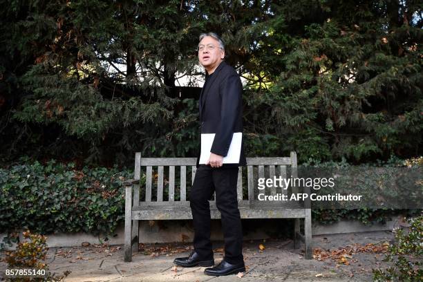 British author Kazuo Ishiguro walks after holding a press conference in London on October 5, 2017 after being awarded the Nobel Prize for Literature....